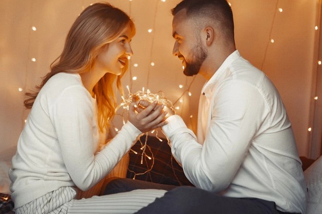 elegant couple sitting with garland